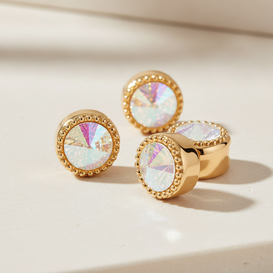 Three iridescent crystal halo loc beads on a cream surface, one turned to show the back opening