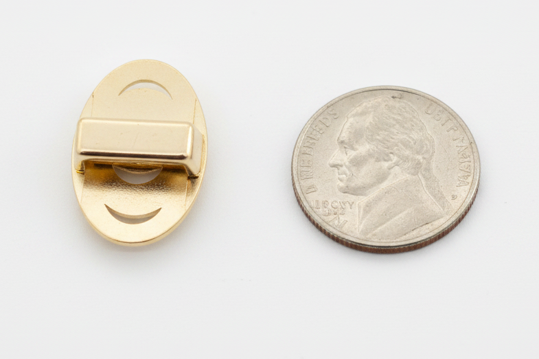 Pearl loc charm back showing the slide bar clip, beside a nickel on white
